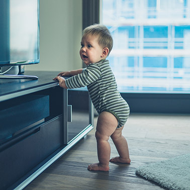 Baby walking store around furniture