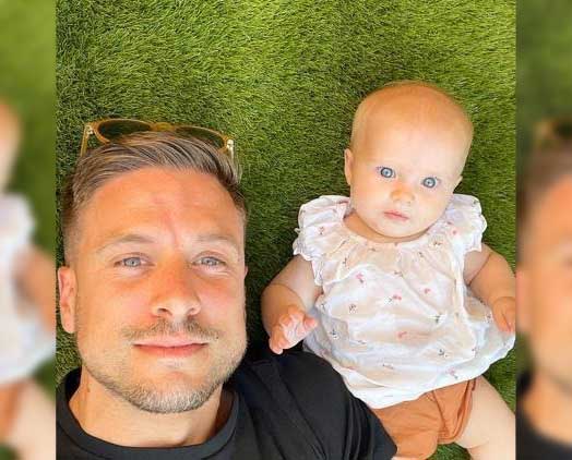 a father and his baby posing for a selfie