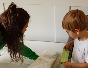 Mom and child changing a bed