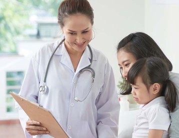 Doctor talking to mom and daughter